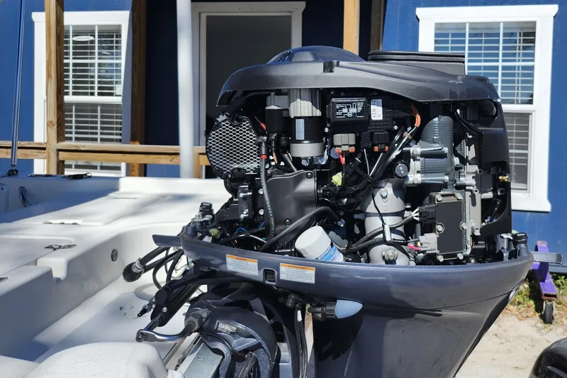 Slide: The Image of 2020 NauticStar 195 NauticBay boat engine with open cover, showcasing internal components. - 39