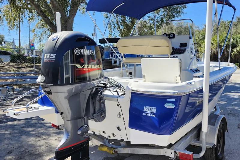 Slide: The Image of 2020 NauticStar 195 NauticBay boat with Yamaha 115 VMAX engine, parked on trailer. - 6