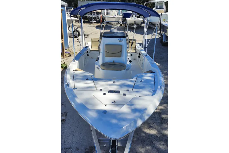 Slide: The Image of 2020 NauticStar 195 NauticBay boat with blue canopy, docked outdoors. - 8