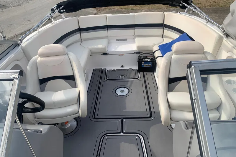 Slide: The Image of 2004 Yamaha Boats AR230 interior with white seating and steering wheel. - 11