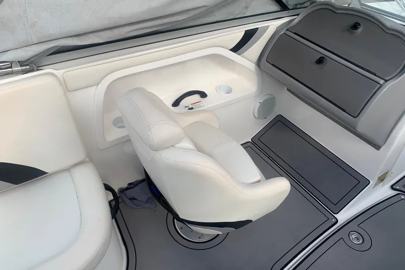 Slide: The Image of 2004 Yamaha AR230 boat interior with white seating and storage compartments. - 12