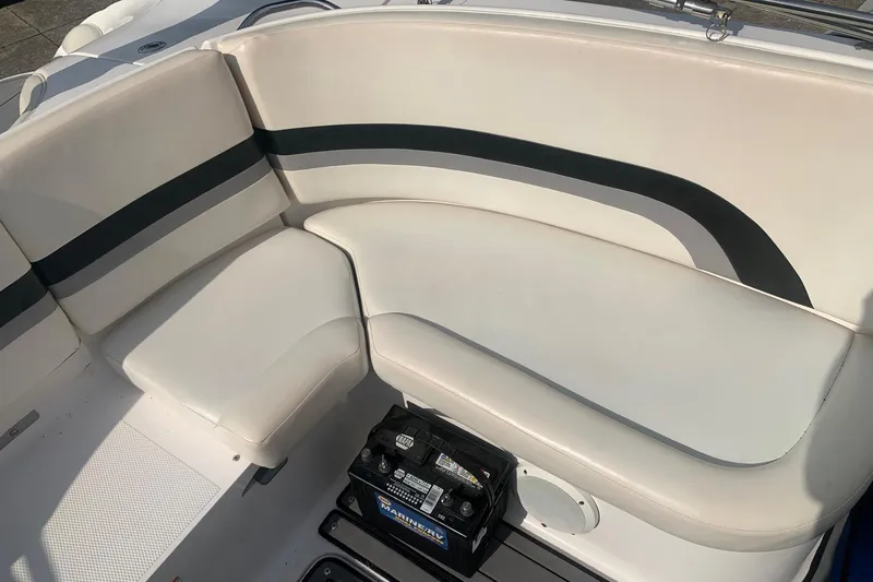 Slide: The Image of 2004 Yamaha AR230 boat interior with white seating and marine battery. - 14