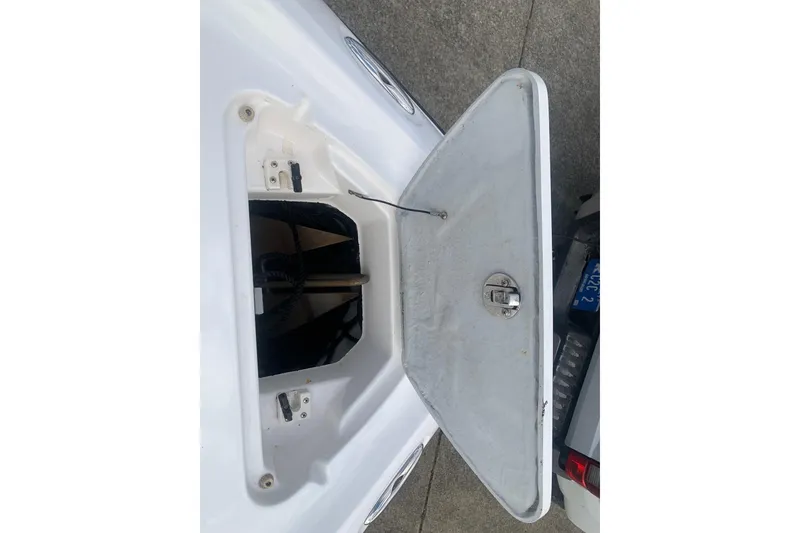 Slide: The Image of Open storage compartment on a 2004 Yamaha Boats AR230, showing interior details. - 16