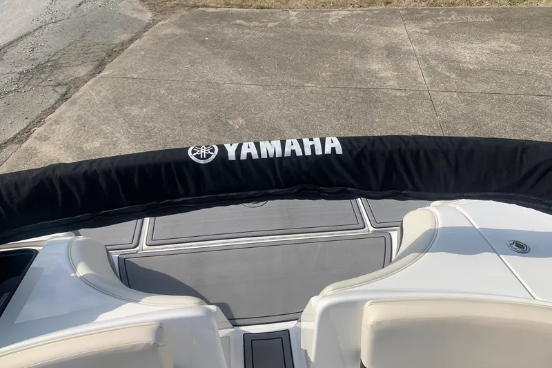Slide: The Image of 2004 Yamaha Boats AR230 with black cover, viewed from the rear on a concrete surface. - 17