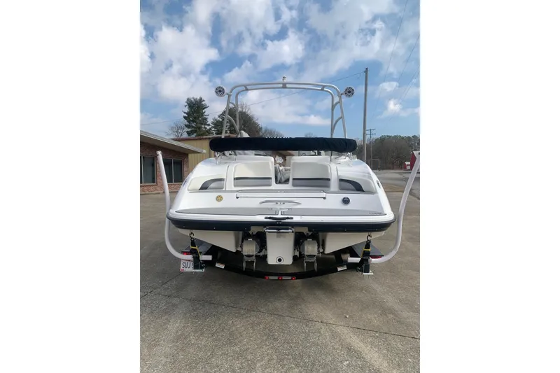Slide: The Image of 2004 Yamaha Boats AR230, rear view, parked on concrete, under a partly cloudy sky. - 4