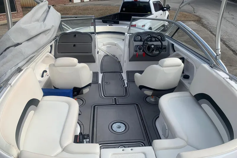 Slide: The Image of 2004 Yamaha Boats AR230 interior with white seating and steering console. - 7