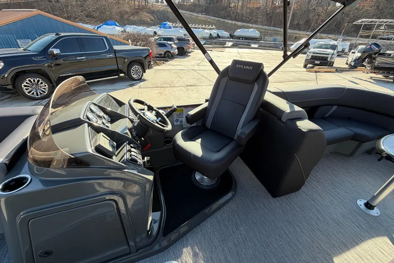 Slide: The Image of Interior of 2026 Sylvan Mirage X X3 boat with steering console and seating. - 12