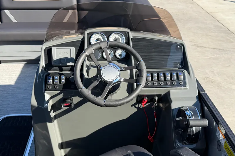 Slide: The Image of 2026 Sylvan Mirage X X3 boat dashboard with steering wheel and control panel. - 6