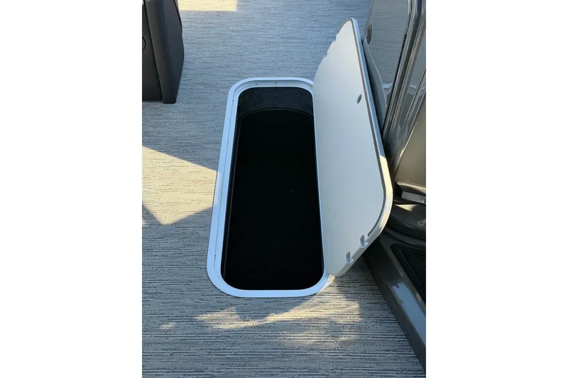 Slide: The Image of Open storage compartment on 2026 Sylvan Mirage X X3 boat deck. - 9