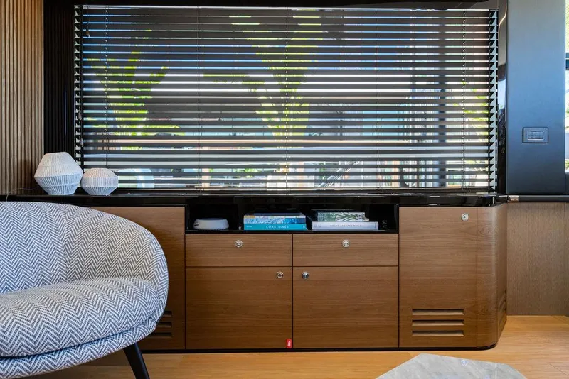 Slide: The Image of Interior of 2023 Absolute 64 Navetta yacht with modern furnishings and window blinds. - 13