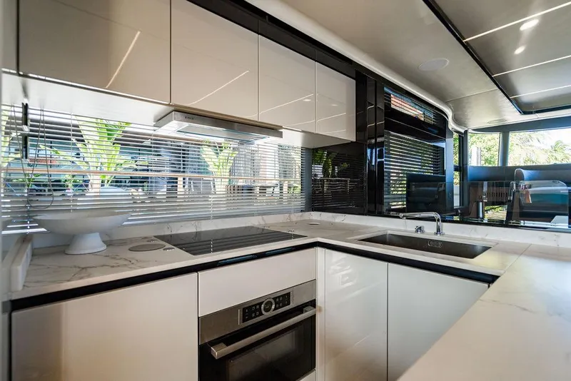 Slide: The Image of Modern kitchen interior on 2023 Absolute 64 Navetta yacht, featuring sleek design and appliances. - 15