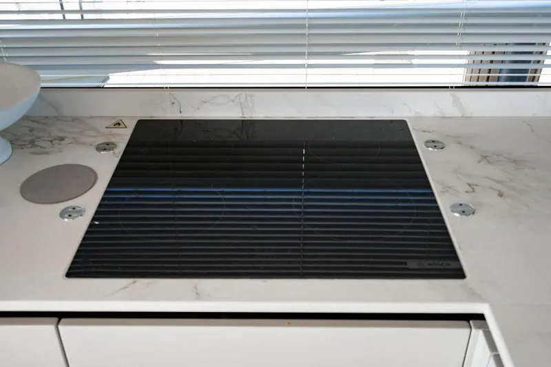 Slide: The Image of Modern stovetop on Absolute 64 Navetta yacht, 2023 model. - 17