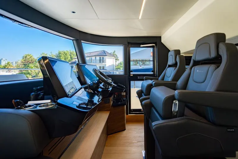 Slide: The Image of Luxurious 2023 Absolute 64 Navetta yacht cockpit with modern navigation systems and plush seating. - 18