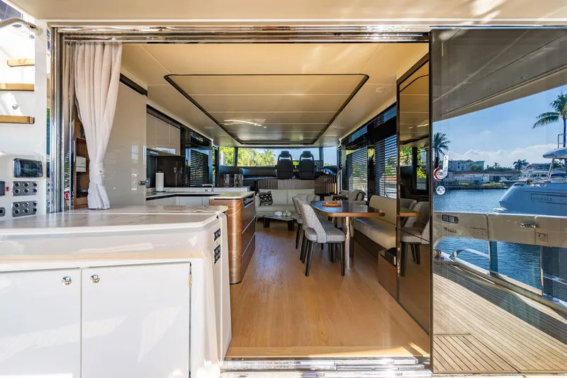 Slide: The Image of Luxurious interior of 2023 Absolute 64 Navetta yacht with modern furnishings and waterfront view. - 2