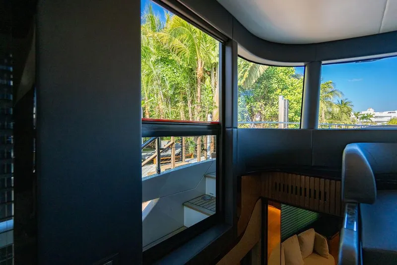 Slide: The Image of Interior view of 2023 Absolute 64 Navetta yacht with lush greenery outside. - 24