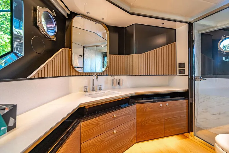 Slide: The Image of Luxurious bathroom in 2023 Absolute 64 Navetta yacht with modern design and wood accents. - 29