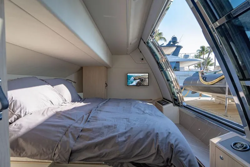 Slide: The Image of Luxurious bedroom in 2023 Absolute 64 Navetta yacht with large windows and modern decor. - 41