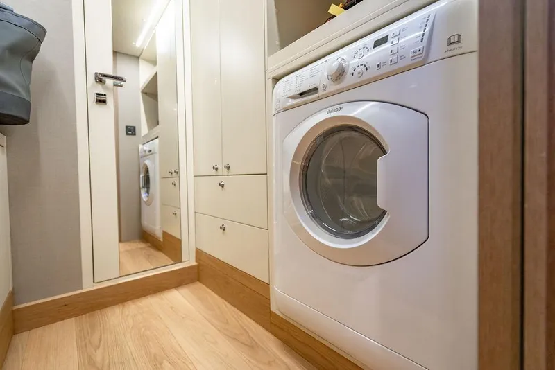 Slide: The Image of Laundry area with washing machine in 2023 Absolute 64 Navetta yacht. - 45
