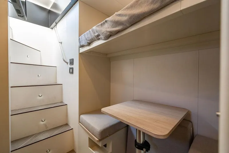 Slide: The Image of 2023 Absolute 64 Navetta interior with compact seating and stairs. - 46