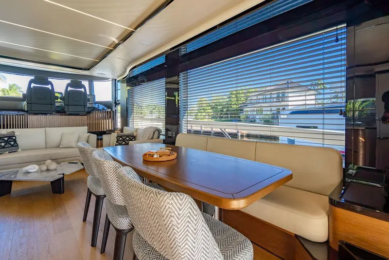 Slide: The Image of Luxurious interior of 2023 Absolute 64 Navetta yacht with elegant dining area and panoramic windows. - 8