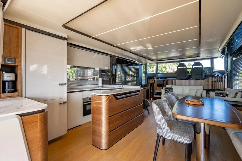 Slide: The Image of Luxurious interior of 2023 Absolute 64 Navetta yacht with modern kitchen and dining area. - 9