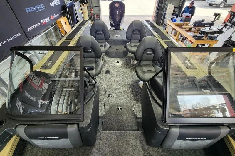 Slide: The Image of 2026 Tracker Targa 185 WT boat interior with seating and equipment in a workshop. - 10
