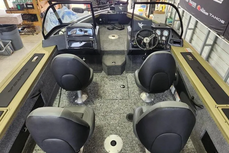 Slide: The Image of 2026 Tracker Targa 185 WT boat interior with four seats and steering console. - 2