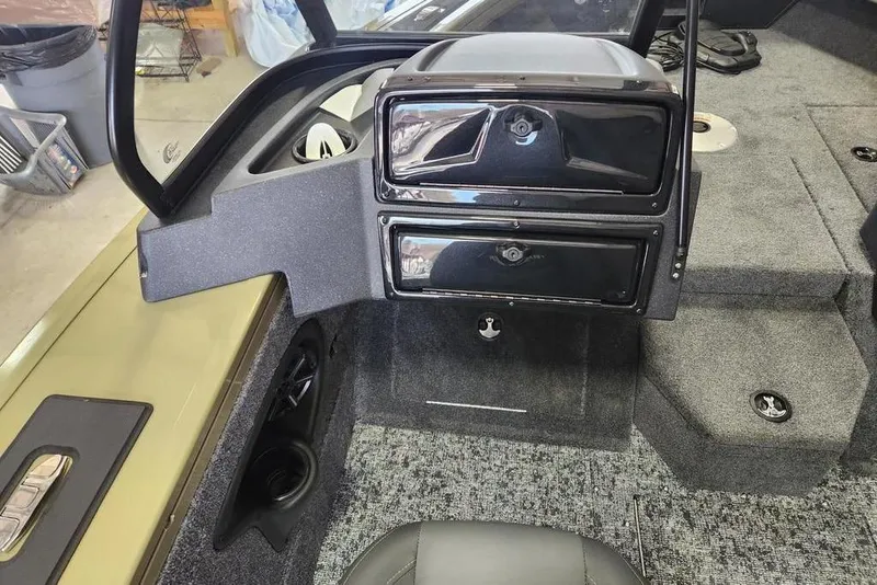Slide: The Image of 2026 Tracker Targa 185 WT boat interior with storage compartments and carpeted flooring. - 3