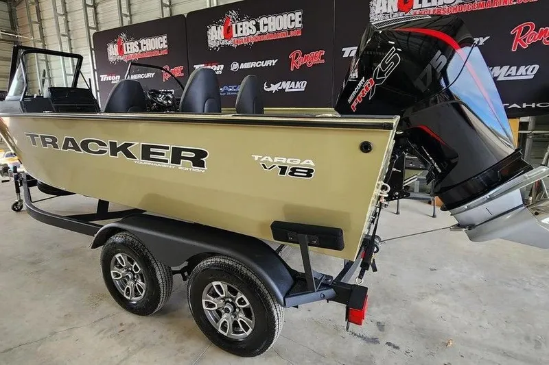 Slide: The Image of 2026 Tracker Targa 185 WT boat on trailer, displayed indoors with promotional banners. - 5