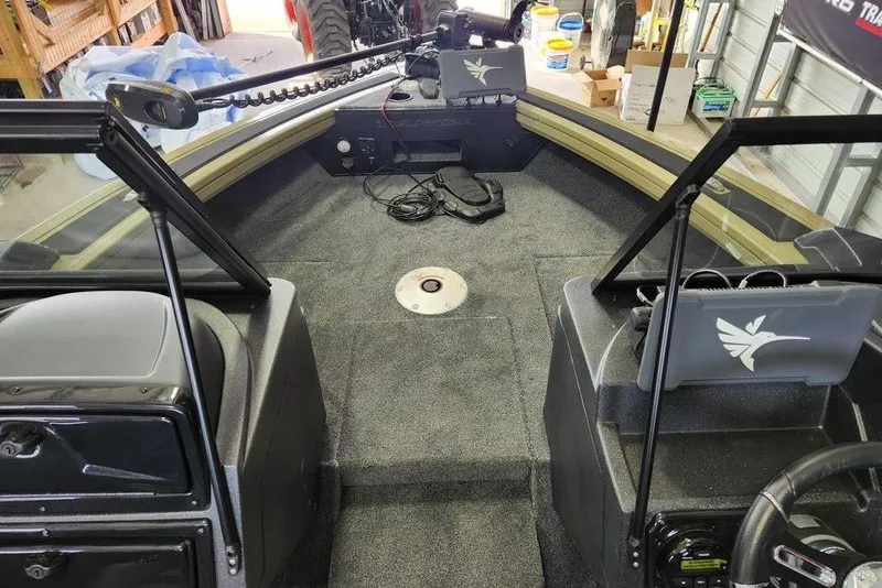 Slide: The Image of 2026 Tracker Targa 185 WT boat interior with carpeted deck and storage compartments. - 9
