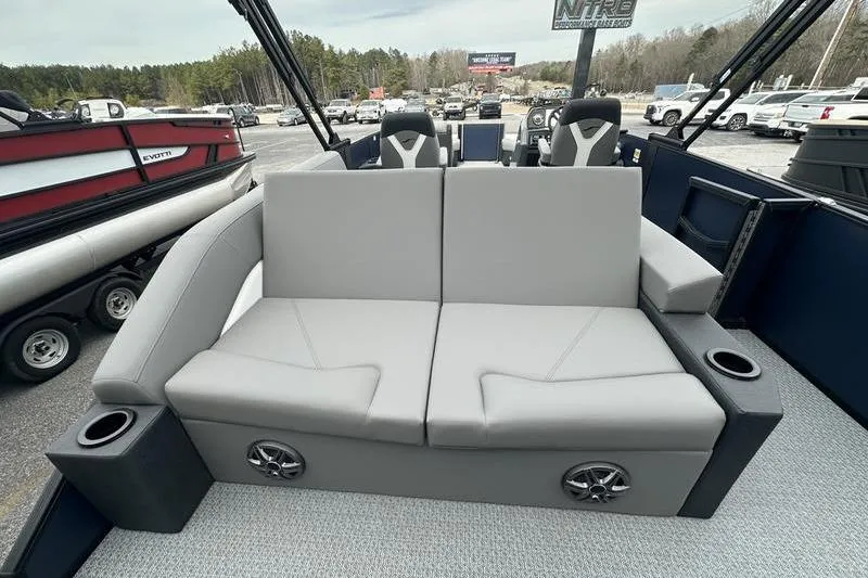 Slide: The Image of 2026 Evotti 523CS boat interior with gray seating, cup holders, and speakers. - 16