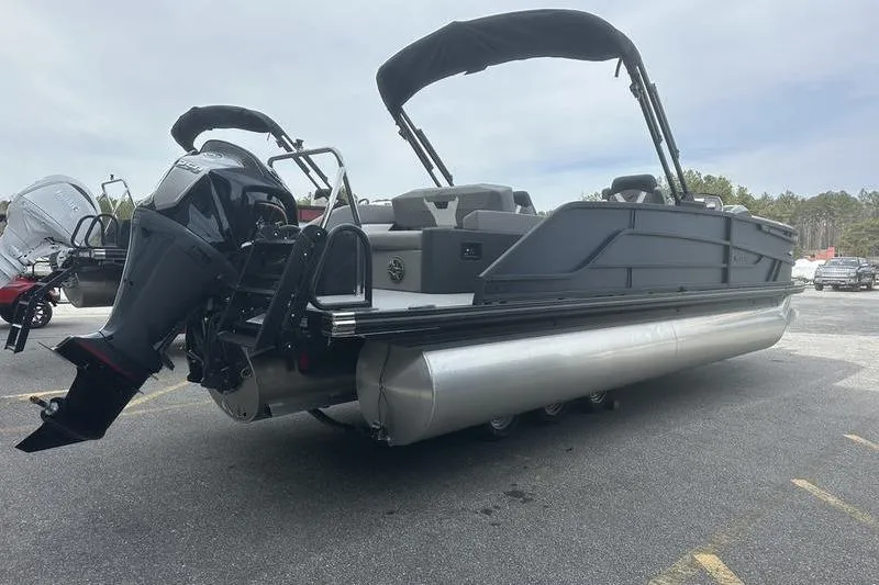 Slide: The Image of 2026 Evotti 523CS pontoon boat with outboard motor, parked on asphalt. - 6