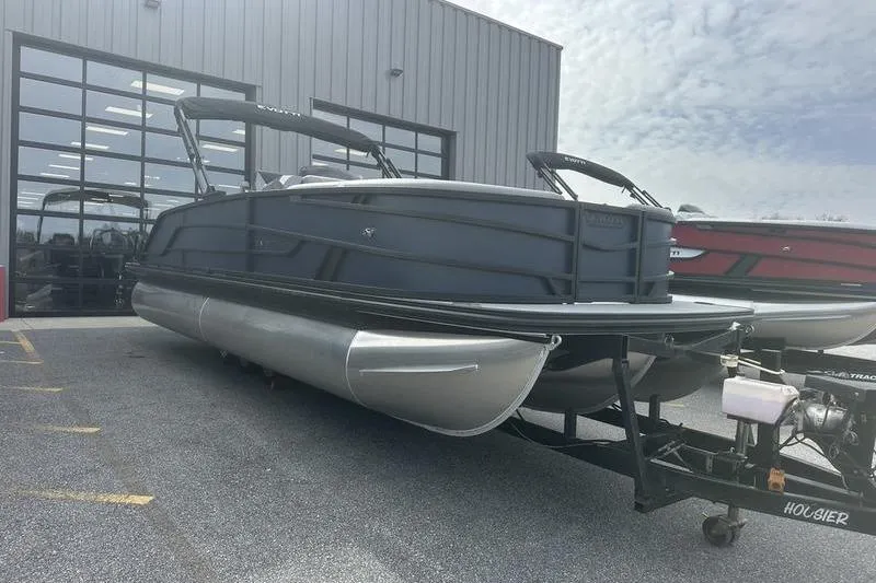 Slide: The Image of 2026 Evotti 523CS pontoon boat on trailer outside a showroom. - 7
