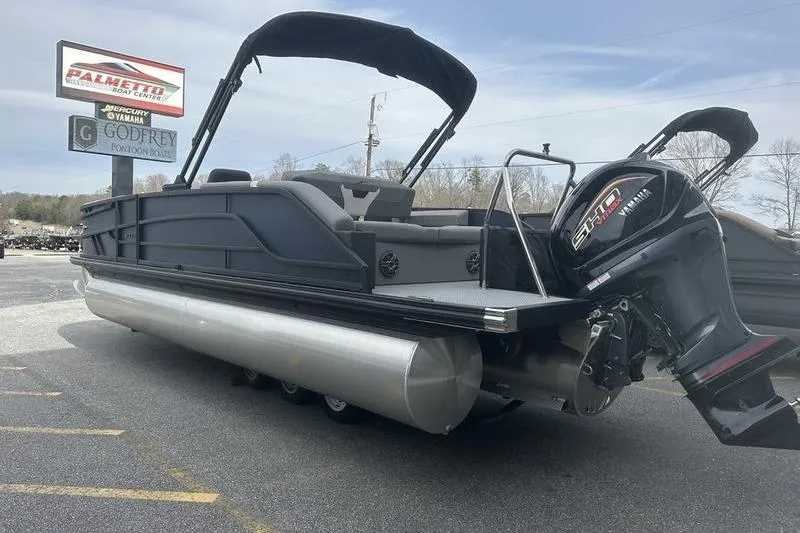 Slide: The Image of 2026 Evotti 523CS pontoon boat with outboard motor at dealership. - 9