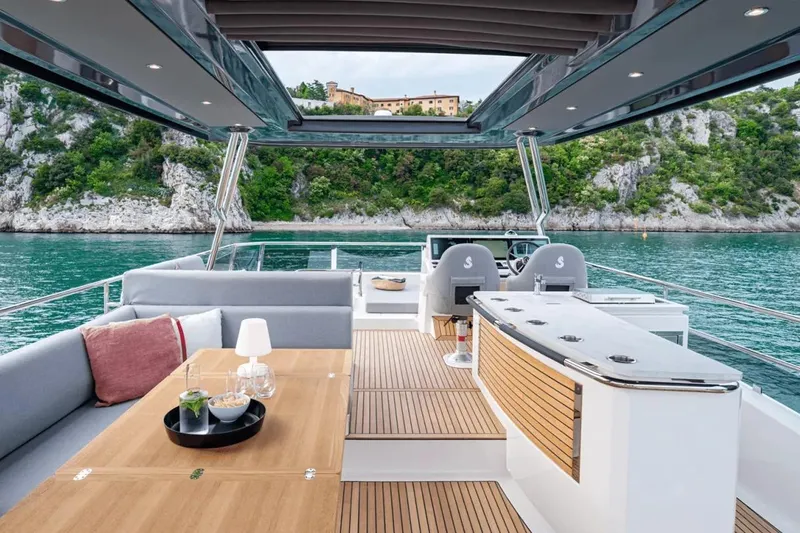 Slide: The Image of Luxurious 2026 Beneteau Grand Trawler 62 yacht interior with scenic ocean view. - 2