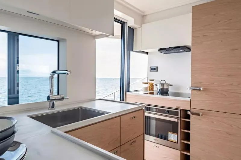 Slide: The Image of Modern kitchen interior on 2026 Beneteau Grand Trawler 62 yacht with ocean view. - 5