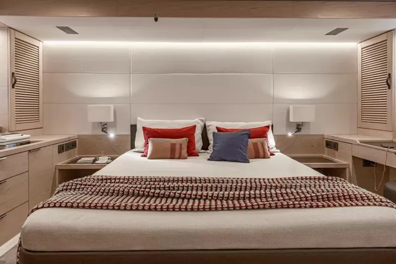 Slide: The Image of Luxurious bedroom interior on 2026 Beneteau Grand Trawler 62 yacht, featuring elegant design and cozy bedding. - 7