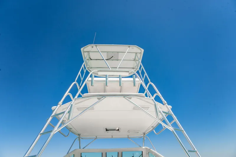 Slide: The Image of 2004 Luhrs 32 Open boat tower against clear blue sky. - 13