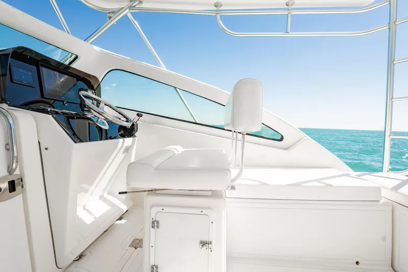 Slide: The Image of 2004 Luhrs 32 Open yacht helm with ocean view and clear blue sky. - 20