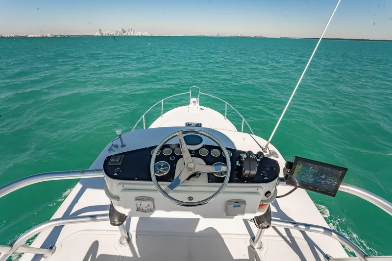 Slide: The Image of 2004 Luhrs 32 Open boat helm with ocean view and distant city skyline. - 28