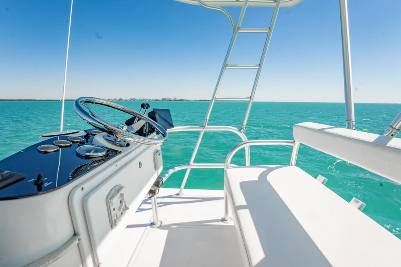 Slide: The Image of 2004 Luhrs 32 Open boat helm with ocean view and clear blue sky. - 29