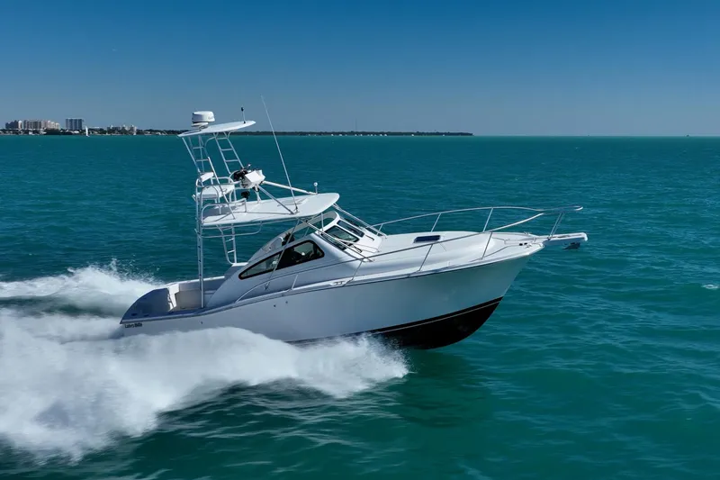 Slide: The Image of 2004 Luhrs 32 Open boat cruising on clear blue ocean waters. - 3