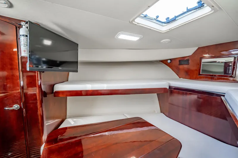 Slide: The Image of Interior of 2004 Luhrs 32 Open boat with wood finish, TV, and skylight. - 34