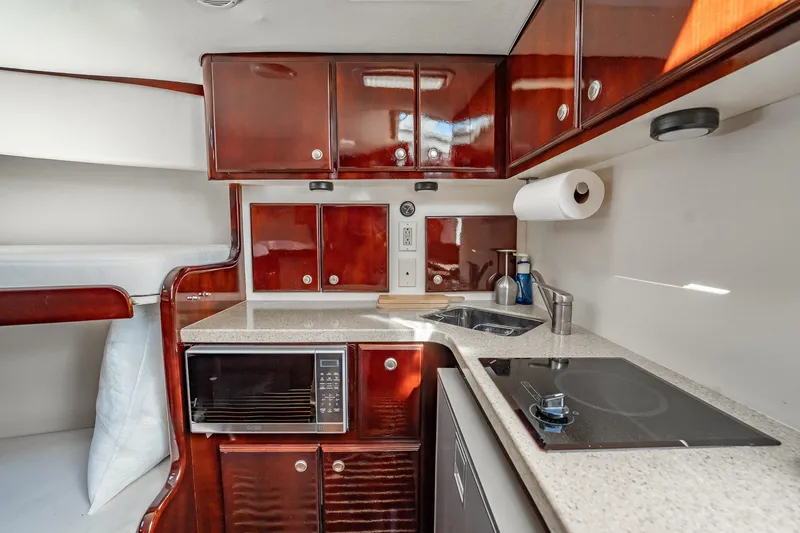 Slide: The Image of Luxurious 2004 Luhrs 32 Open yacht kitchen with modern amenities and sleek cabinetry. - 42