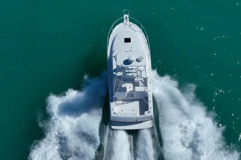 Slide: The Image of 2004 Luhrs 32 Open boat cruising on turquoise water, aerial view. - 51