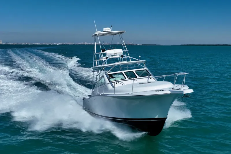 Slide: The Image of 2004 Luhrs 32 Open yacht cruising on blue ocean waters. - 54
