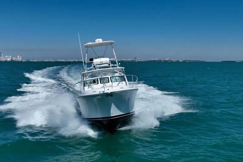 Slide: The Image of 2004 Luhrs 32 Open boat cruising on clear blue ocean waters. - 61