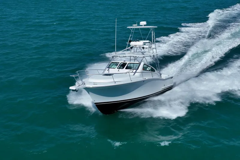 Slide: The Image of 2004 Luhrs 32 Open boat cruising on clear blue ocean waters. - 63