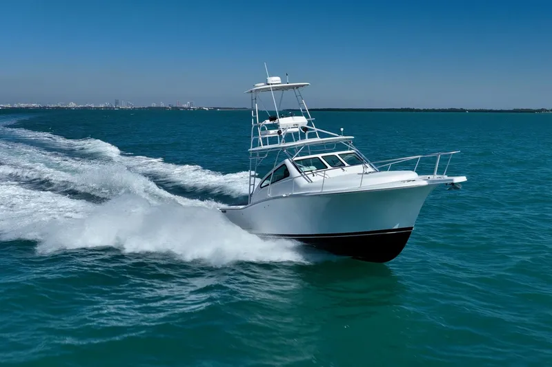 Slide: The Image of 2004 Luhrs 32 Open boat cruising on clear blue ocean waters. - 65