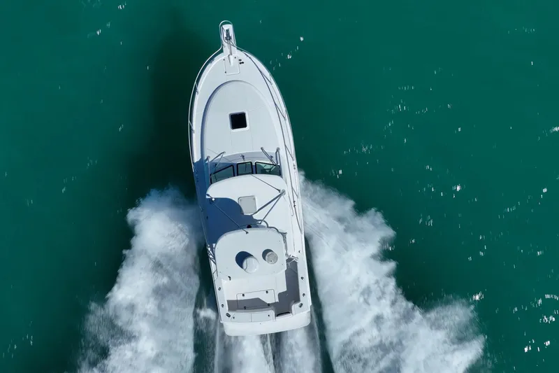 Slide: The Image of Aerial view of 2004 Luhrs 32 Open boat cruising on turquoise water. - 66